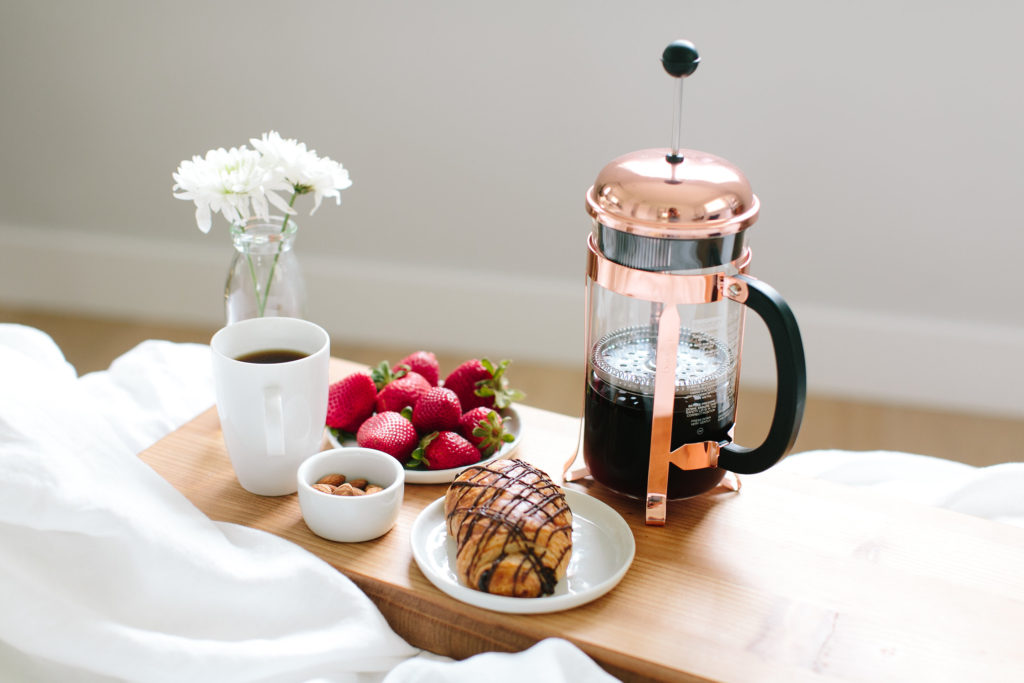 Breakfast in bed featuring strawberries, a cup of coffee, a french press, nuts and a pain au chocolat

The Kristi Jones Podcast -Morning Routines-Why They Are Important