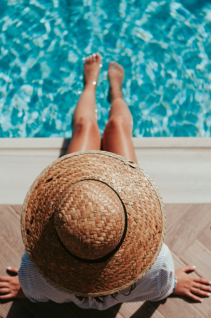 Woman wearing a large hat sitting by the pool with her feet in the water 

Embrace Summer Vibes: Create Your Ultimate Bucket List , The Kristi Jones Podcast Show

